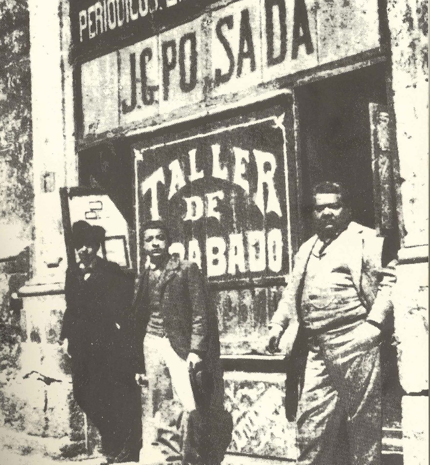 Posada and a couple of men standing outside of a building.